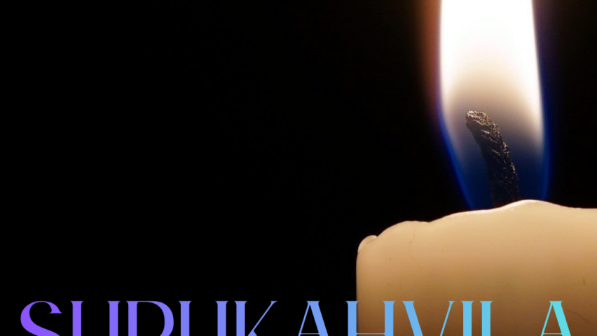 kynttilä tummaa taustaa vasten