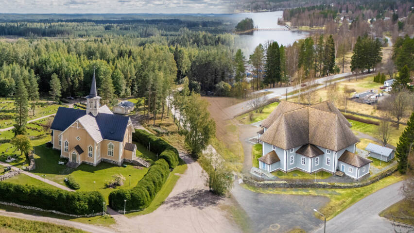 Kaksi kirkkoa kesäisessä maisemassa ilmasta kuvattuna.